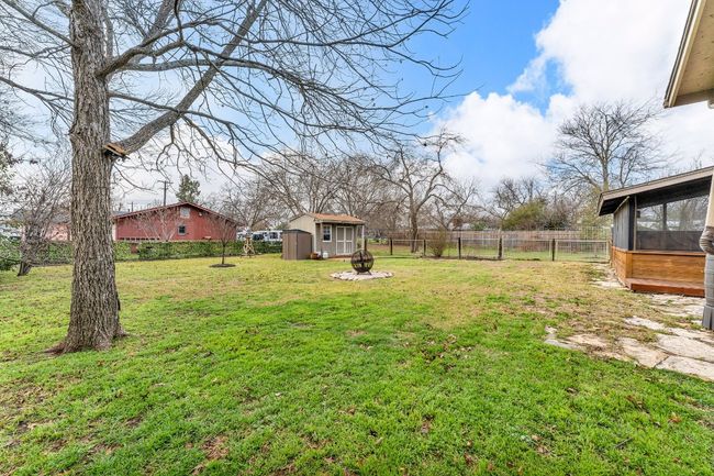 View of yard with a storage unit, an outdoor structure, and a fenced backyard | Image 25