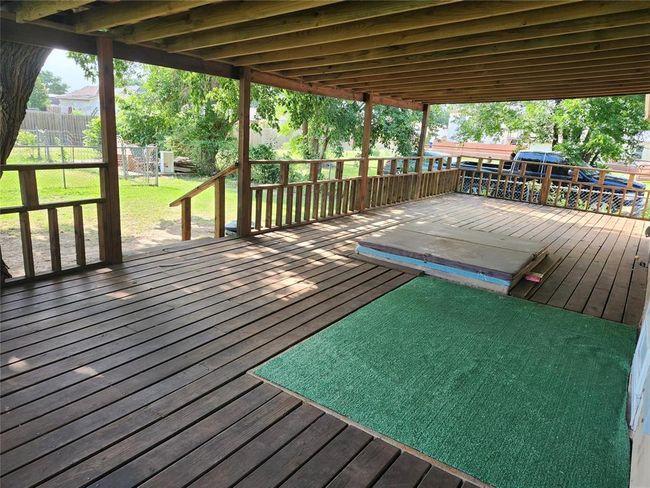 Wooden deck with a lawn | Image 9