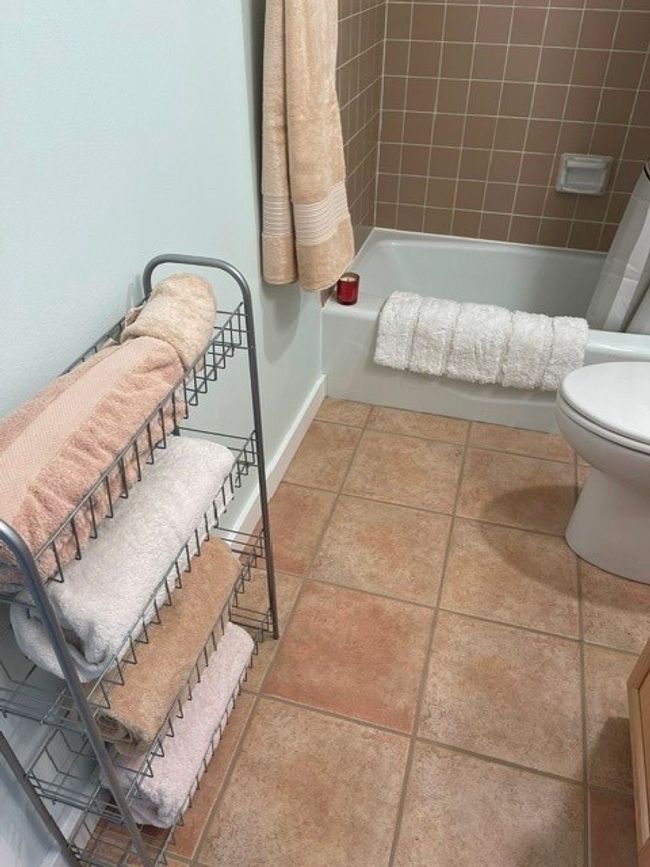 Bathroom with shower / bath combo, toilet, and baseboards | Image 14