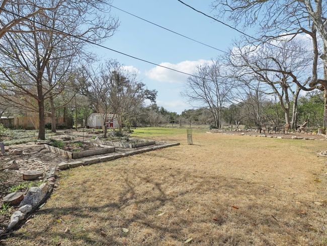 View of yard with a vegetable garden, an outdoor structure, and a shed | Image 39