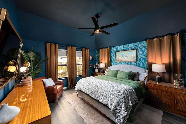 Bedroom featuring wood type floors, a ceiling fan, upgraded paint and wallpaper | Image 10