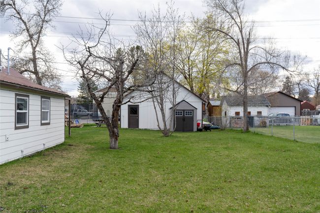View of yard featuring an outdoor structure and fence | Image 43