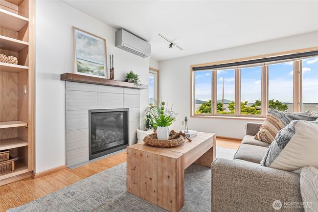 Tiled fireplace and views of the bay facing West. | Image 4