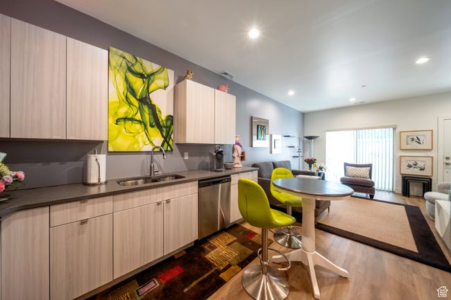 Kitchen featuring a sink, open floor plan, dishwasher, dark wood-style floors, and recessed lighting | Image 7