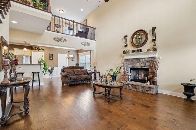 The elegant wood staircase and catwalk overhead add architectural charm and a sense of openness. 1107 Sycamore Leaf Way Murfreesboro, TN 37129 | Image 6