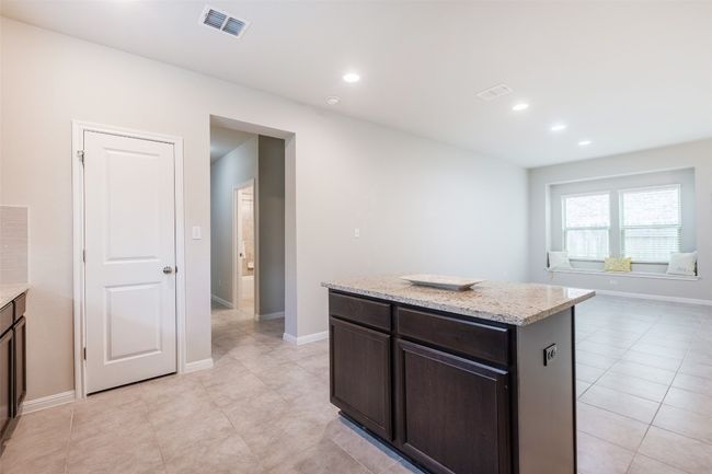 Kitchen featuring visible vents, recessed lighting, and a center island | Image 15
