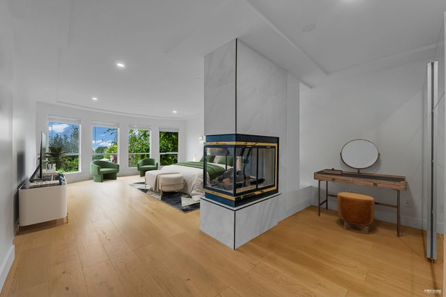 Living room featuring light wood-style floors, a multi sided fireplace, recessed lighting, and baseboards | Image 23