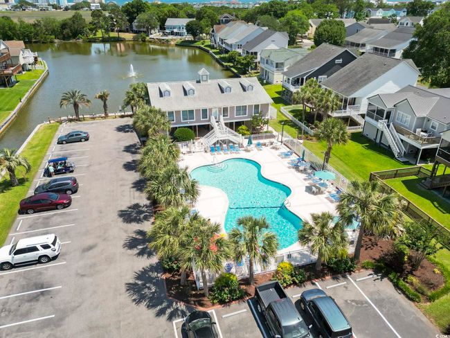 Aerial perspective of suburban area with a pool area and a large body of water | Image 29
