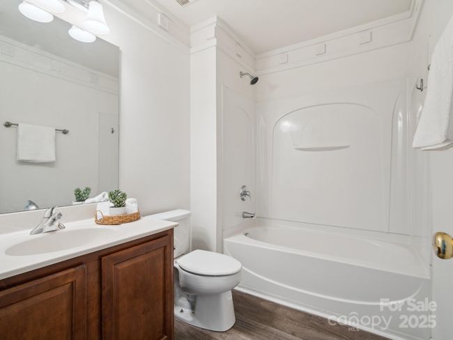 Guest Bathroom has Laminate flooring and crown molding | Image 21
