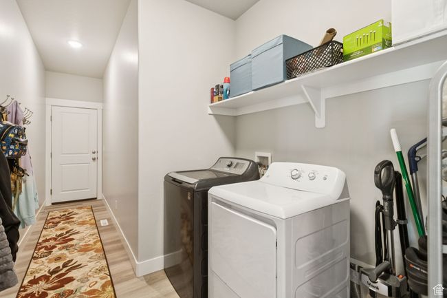 Washroom with washer and clothes dryer and light wood finished floors | Image 29