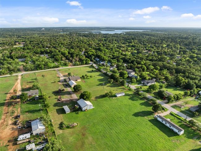 Bird's eye view of a heavily wooded area and a large body of water | Image 12