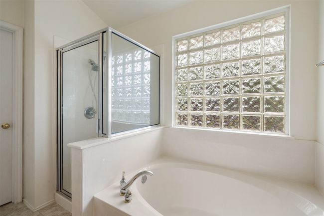 Bathroom with a stall shower and a garden tub | Image 27
