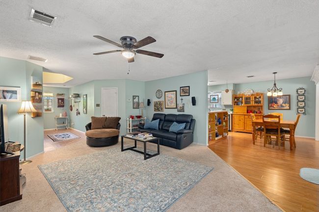 The living room is open to the dining area. | Image 7