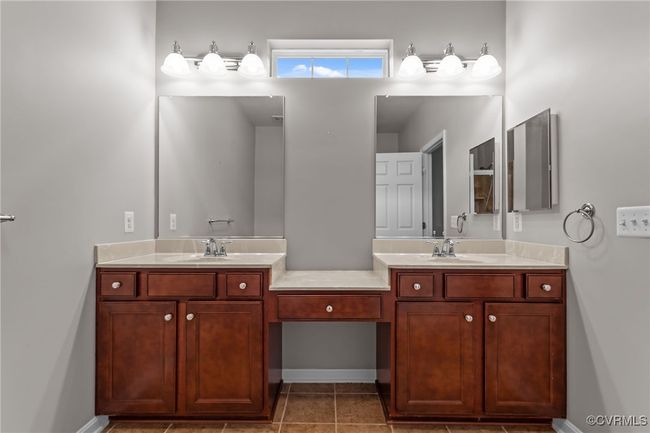 Bathroom with double vanity and tile patterned flooring | Image 19