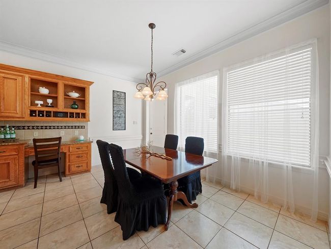 Cozy breakfast nook with seamless kitchen access. | Image 17