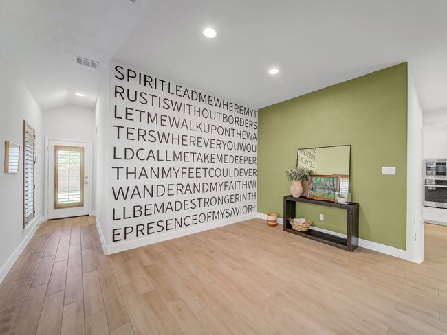 Unfurnished room with wood finished floors, recessed lighting, and lofted ceiling | Image 16