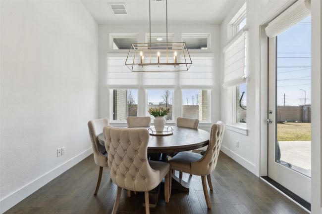 Dining space featuring a chandelier, healthy amount of natural light, and baseboards | Image 13