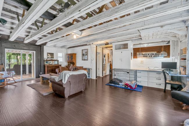 Living area featuring dark wood finished floors and beamed ceiling | Image 19