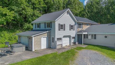 We start at the back unit, entering through the covered porch. Also with this unit is a 1-car garage and extra "pool house" shed attached at the left. Great for storage, tools and landscaping equipment. | Image 2