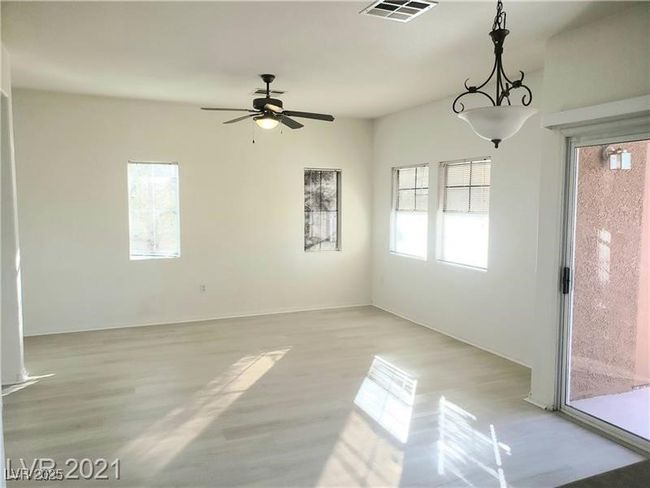 Spare room with light wood-style flooring and a ceiling fan | Image 8