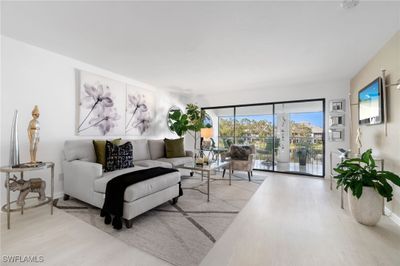 Living room featuring light wood-type flooring | Image 1