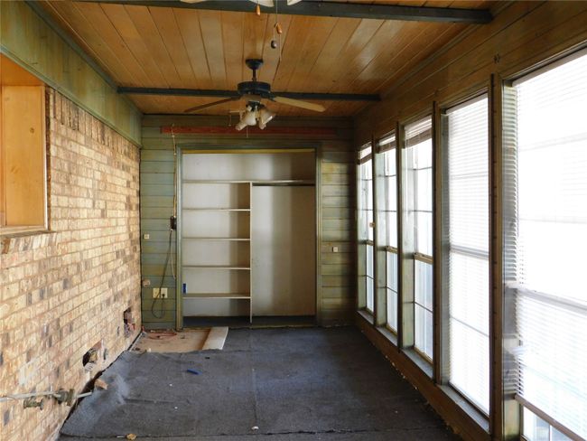 Unfurnished sunroom featuring ceiling fan and wood ceiling | Image 8