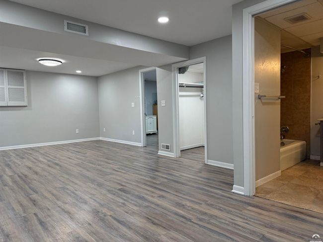 Need more beds or a gym? 25'x13' hotel-like space has egress window, full bathroom, & walk-in closet | Image 50