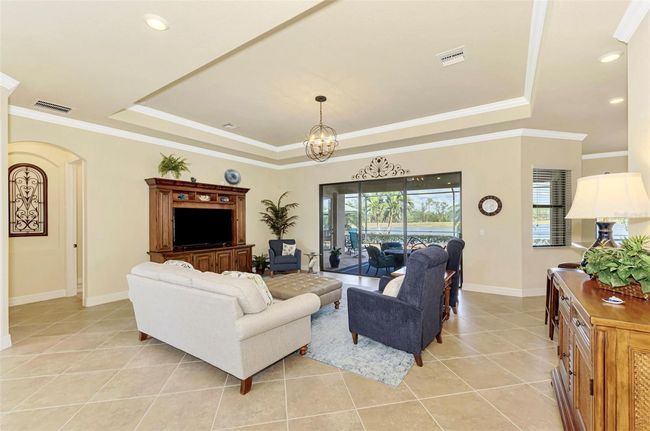 Great Room with Tray Ceiling and Crown Molding w/Tile Floors | Image 16