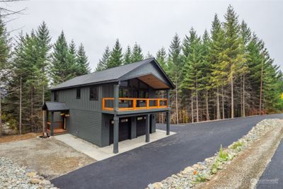 Front of the home showing long blacktop driveway. | Image 2