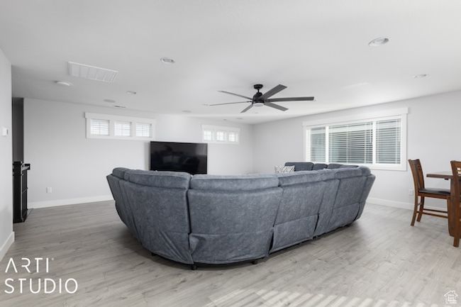Living room featuring baseboards, wood finished floors, visible vents, and ceiling fan | Image 37