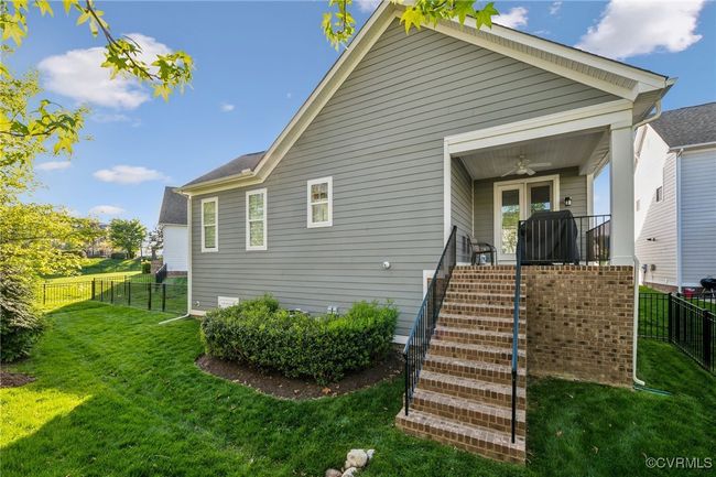 Rear covered porch with overhead fan accessed from the breakfast nook. | Image 45