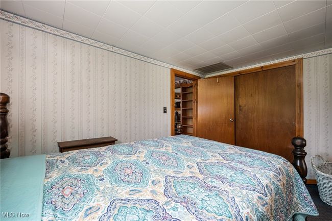 Bedroom featuring wallpapered walls | Image 18