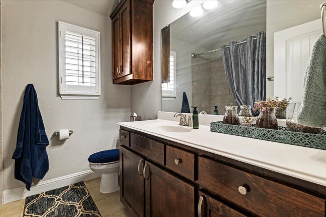 Bathroom with toilet, tile patterned floors, a healthy amount of sunlight, and vanity | Image 33