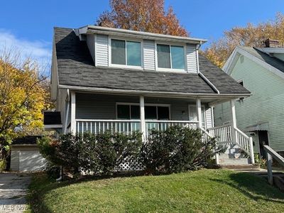 View of front facade featuring a garage, a front yard, and covered porch | Image 1