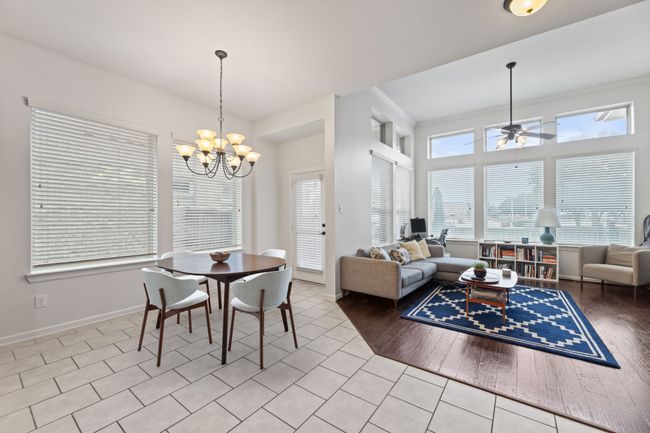 Dining space with a chandelier, ceiling fan, baseboards, and light tile patterned floors | Image 16