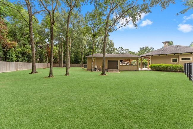 The separate guest quarters includes a 5th garage bay for storage purposes -perfect for storing a golf cart, lawn equipment, and pool supplies—providing added convenience and organization for outdoor living.. | Image 42
