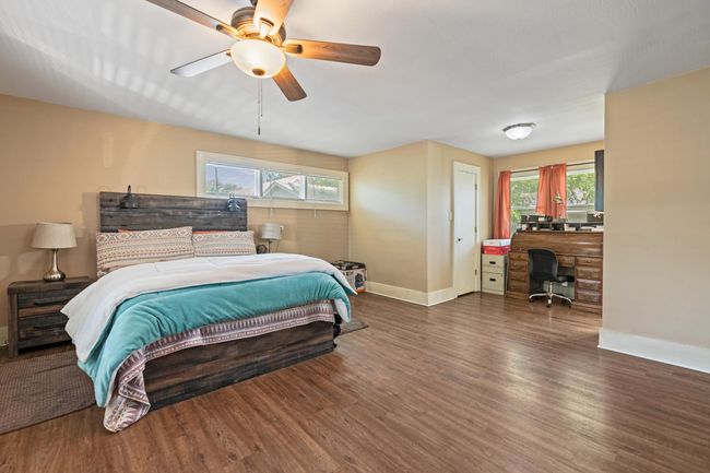 Bedroom featuring baseboards, wood finished floors, an office area, and ceiling fan | Image 10