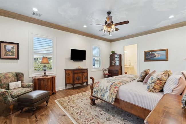 The Primary Bedroom is a beautiful, relaxing, restful retreat featuring "Versailles" 1/2" thickHickory Wood flooring from "Olde Time Luxe" Collection by RegalHardwood. | Image 21