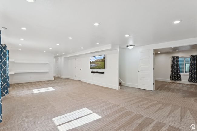 Unfurnished living room featuring light colored carpet and recessed lighting | Image 23