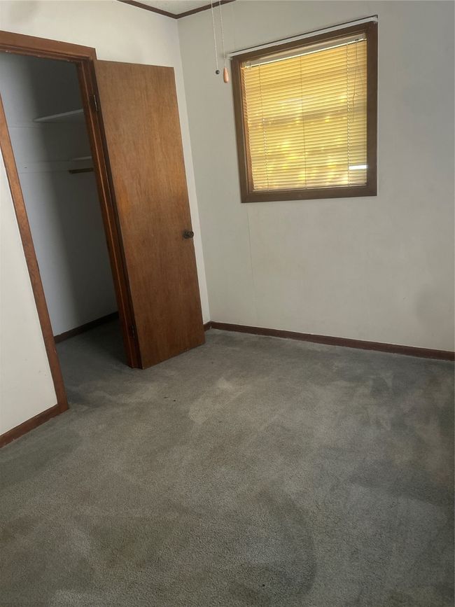 Unfurnished bedroom featuring carpet, baseboards, and a closet | Image 6