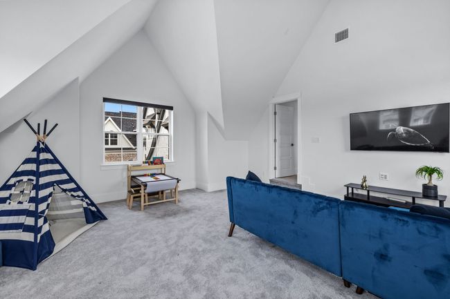 Living room featuring carpet flooring and vaulted ceiling | Image 28