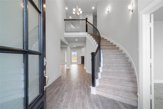Welcome inside 461 Piney Rocks where you are greeted with this beautiful and bright space featuring the grand staircase, recessed lighting and gorgeous wood-look tile flooring! | Image 4