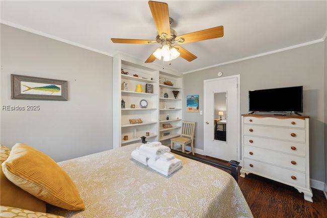 Second bedroom with stylish built in shelving, ample natural lighting if desired, hardwood floors. | Image 50