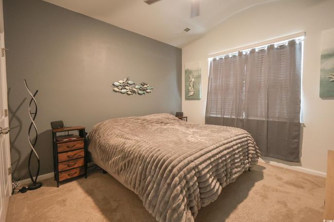 Bedroom with ceiling fan, vaulted ceiling, baseboards, and light carpet | Image 20