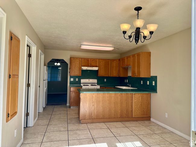 The kitchen and dining area are thoughtfully designed with space and function in mind | Image 5