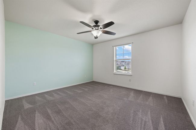 Unfurnished room with carpet flooring, baseboards, and a ceiling fan | Image 27