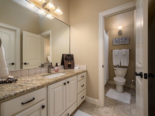Full bath featuring baseboards, vanity, and toilet | Image 29