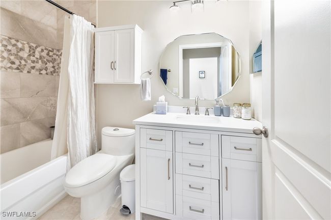 Full bathroom with vanity, shower / tub combo with curtain, toilet, and tile patterned floors | Image 17