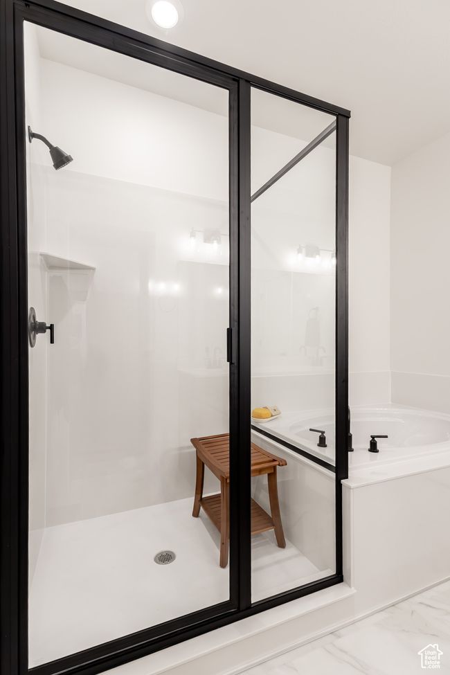 Full bath featuring a shower stall and a bath | Image 13