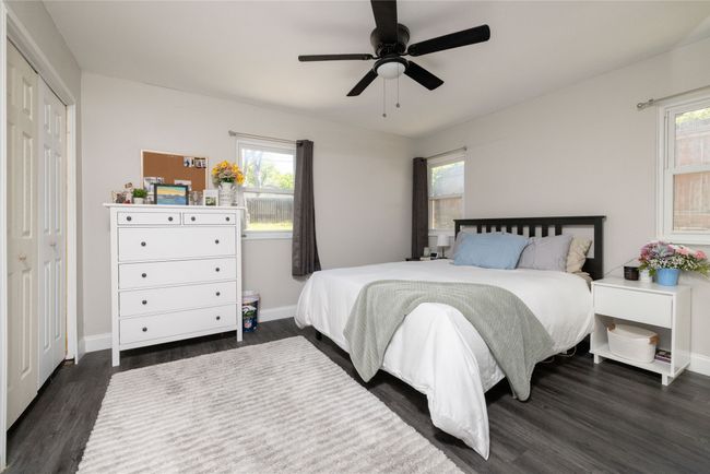 Bedroom with baseboards, multiple windows, and dark wood finished floors | Image 24